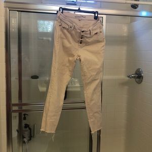 Women’s cream colored jeans 10/30 with distressed bottoms